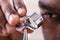 Jeweler Examining Diamond Through Loupe