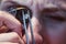 Jeweler looking at precious stone through a loupe