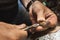 A jeweler removes pearls from a gold ring, is engaged in disassembling it in a workshop