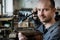 Jeweler silver soldering in his workshop