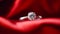 Jewellery, proposal and holiday gift, diamond engagement ring on red silk satin fabric, symbol of love, romance and