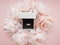 In the jewelry box there is a ring in a frame of pink delicate peonies on a beautiful pink background. Romantic concept. Flat