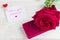 Jewelry gift box and bautiful red rose on wooden background