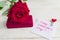 Jewelry gift box and bautiful red rose on wooden background. Present for Valentine`s day