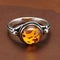 jewelry ring with a amber on a stone surface