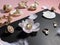 Jewelry white pearl gold rings on a black background with pink opal  seashell rose petals and feathers concept woman accessory bac