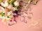 Jewelry women accessories white pearl rings and earrings with tulip Bouquet pink and gold cosmetic case on blue background, costum