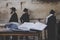 Jewish bible - Torrah on table on blurred background of praying Jews and wailing western wall. Israel. Jerusalem