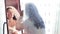 A Jewish bride in a dress and veil in front of a mirror applies makeup before the chuppah ceremony.