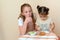 Jewish children dipping apple slices into honey on Rosh HaShanah.