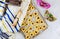 Jewish cookies Haman ears in baking pan for Purim with mask, tallit and noisemaker