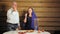 Jewish family husband and wife near the festive table with candles dip an apple in honey and eat.