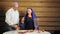 A Jewish family, a husband and wife near the festive table and candles, dip challah in honey and eat