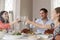 Jewish family raising glasses at the table for Shabbat meal