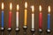 Jewish Festival of Lights Hanukkah holiday menorah candles in red blue yellow and white