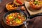 Jewish food cholent and shpkshuka on a laid Shabbat table.