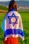 Jewish girl with flag of Israel on amazing landscape in beautiful summer.