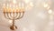 Jewish Hanukkah Menorah candlestick on a blurred background.