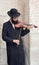 Jewish hasidic play violin near the Tower of David