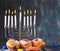 Jewish holiday Hanukkah background. A traditional dish is sweet donuts. Hanukkah table setting a candlestick with