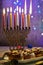 Jewish holiday Hanukkah background. A traditional dish is sweet donuts. Hanukkah table setting a candlestick with candles and