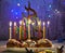 Jewish holiday Hanukkah background. A traditional dish is sweet donuts. Hanukkah table setting a candlestick with candles and