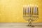 Jewish holiday Hanukkah background with vintage menorah over lights bokeh.