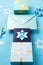 Jewish holiday Hanukkah concept - Gift boxes, stars of David and white candles on blue paper background