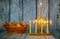 Jewish holiday Hanukkah. Sweet donuts and menorah with burning candles