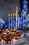 Jewish holiday Hanukkah. Sweet donuts and menorah with burning candles