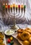 Jewish holiday Hanukkah symbols against white background; traditional spinning top, menorah traditional candelabra, `Sfinj `Donu