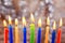 Jewish holiday Menorah Beautiful menorah with burning candles on light blurred background.