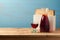 Jewish holiday Passover concept with wine and matzoh over wooden blue background