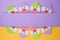 Jewish holiday Purim background with childish paper clowns