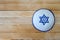 Jewish kippah hat with star of David on wooden background with a copy space