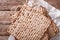 Jewish kosher matzo for Passover closeup on a wooden table. horizontal top view