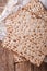 Jewish kosher matzo for Passover macro on a wooden table. vertical top view
