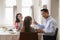 Jewish man holding kiddish cup blesses his family at Shabbat