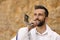 Jewish man in kippah and tallit blowing shofar. Rosh Hashanah celebration