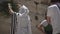 Jewish man pray alone at the wailing wall, Cotel. Strength his believe and faith to god wearing a Tallit and Tefillin