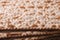 Jewish matzo Flatbread texture close-up, horizontal