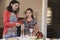 Jewish mother and daughter lighting candles for Shabbat meal