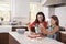 Jewish mother and daughter preparing dough for challah bread