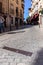 The Jewish Quarter metal sign on the cobbled street of Toledo, Spain, buildings in the background.