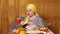 A Jewish woman at a covered Shabbat table reads a siddur prayer