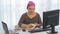 Jewish woman in a headdress in the office writes information in a diary