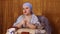 A Jewish woman in a Kisui Rosh headdress, a teacher of tradition, answers women's questions by gesturing with her