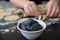 Jewish woman preparing Hamantash cookies with Poppy seeds cream