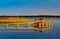 Jezioro Selmet Wielki lake landscape with vintage pier, reeds and wooded shoreline in Sedki in Masuria region of Poland