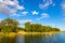 Jezioro Selmet Wielki lake landscape with vintage pier reeds and wooded shoreline in Sedki village in Masuria region of Poland